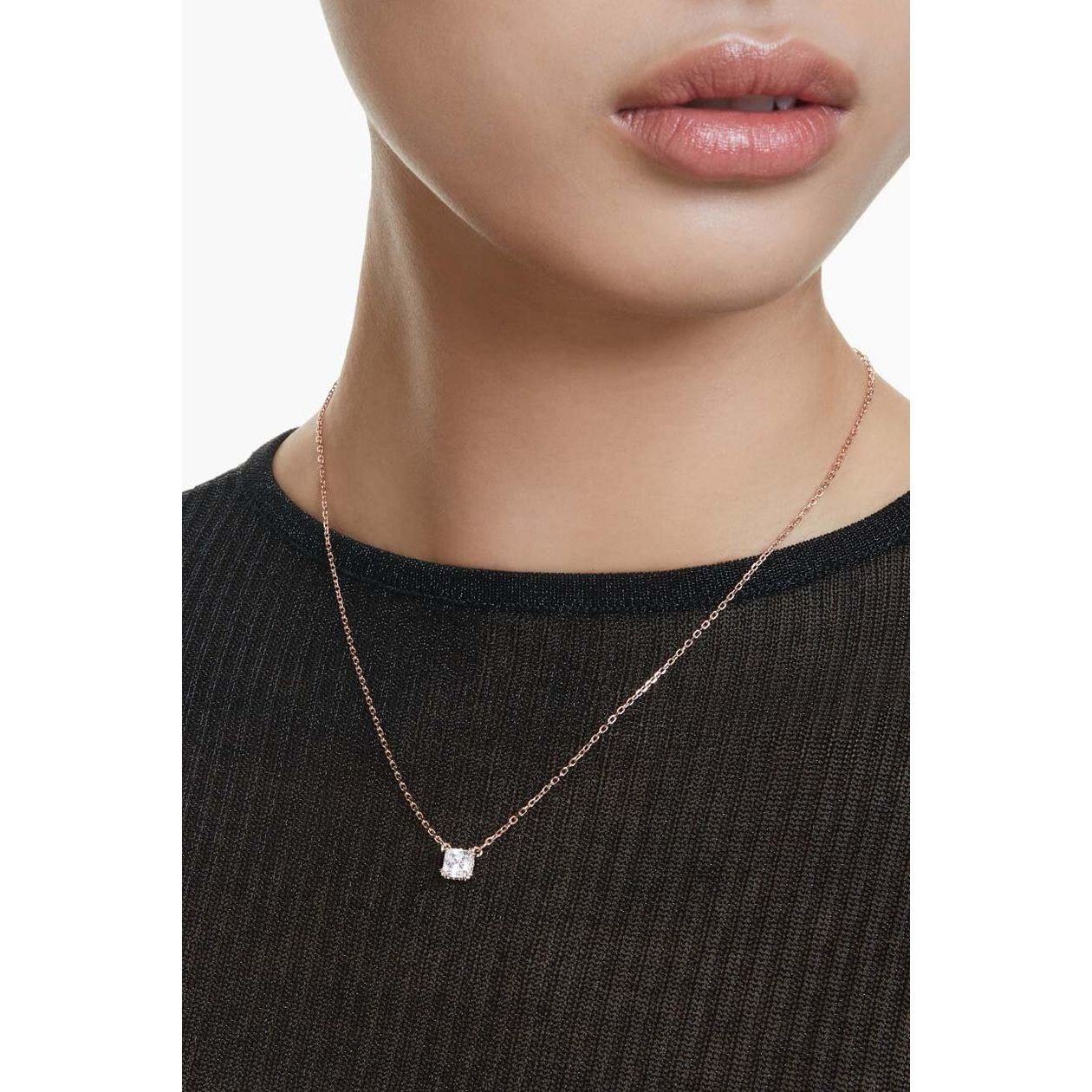 Elegant lady wearing a minimalist necklace showcasing a sparkling pendant.