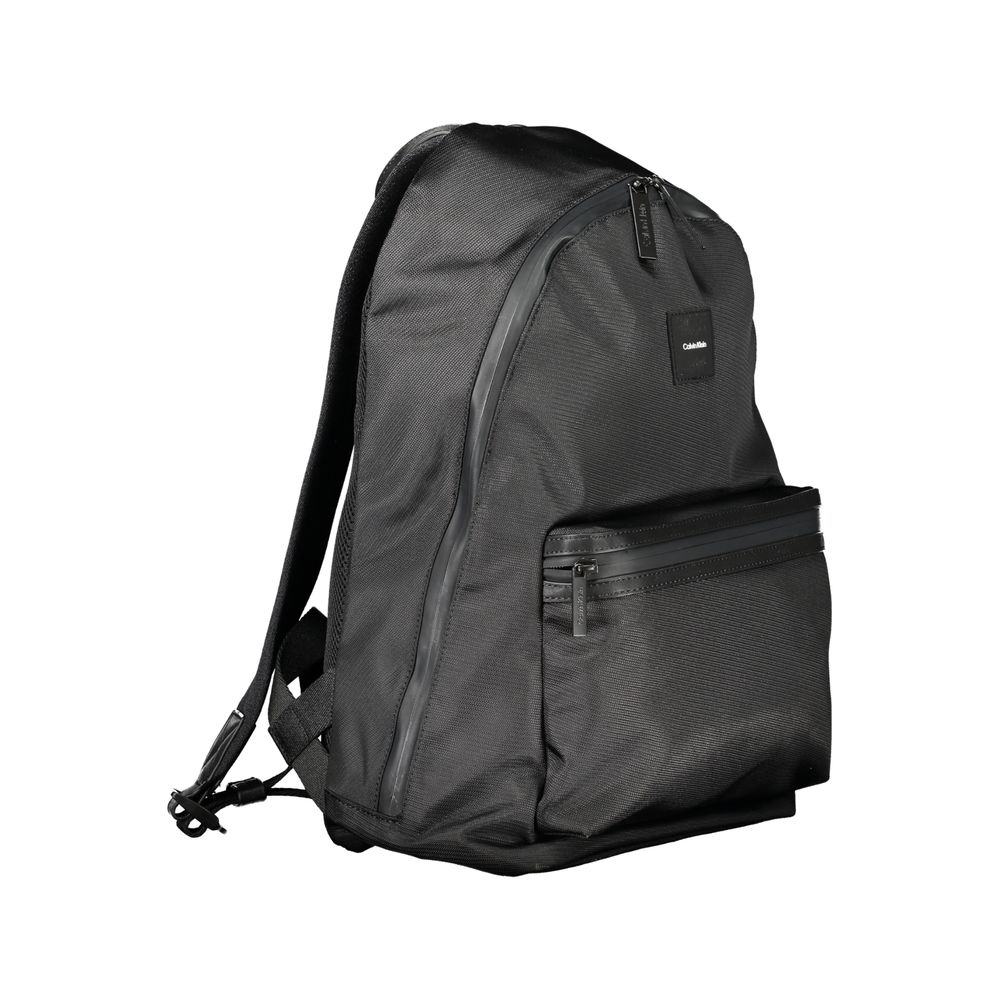 Calvin Klein Black Polyester Men Backpack with sleek design and adjustable straps, featuring a water-repellent exterior and laptop compartment.