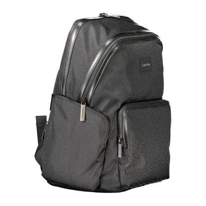 Calvin Klein Black Polyester Backpack with handle, adjustable straps, zip closure, side pockets, laptop compartment, and logo detailing.