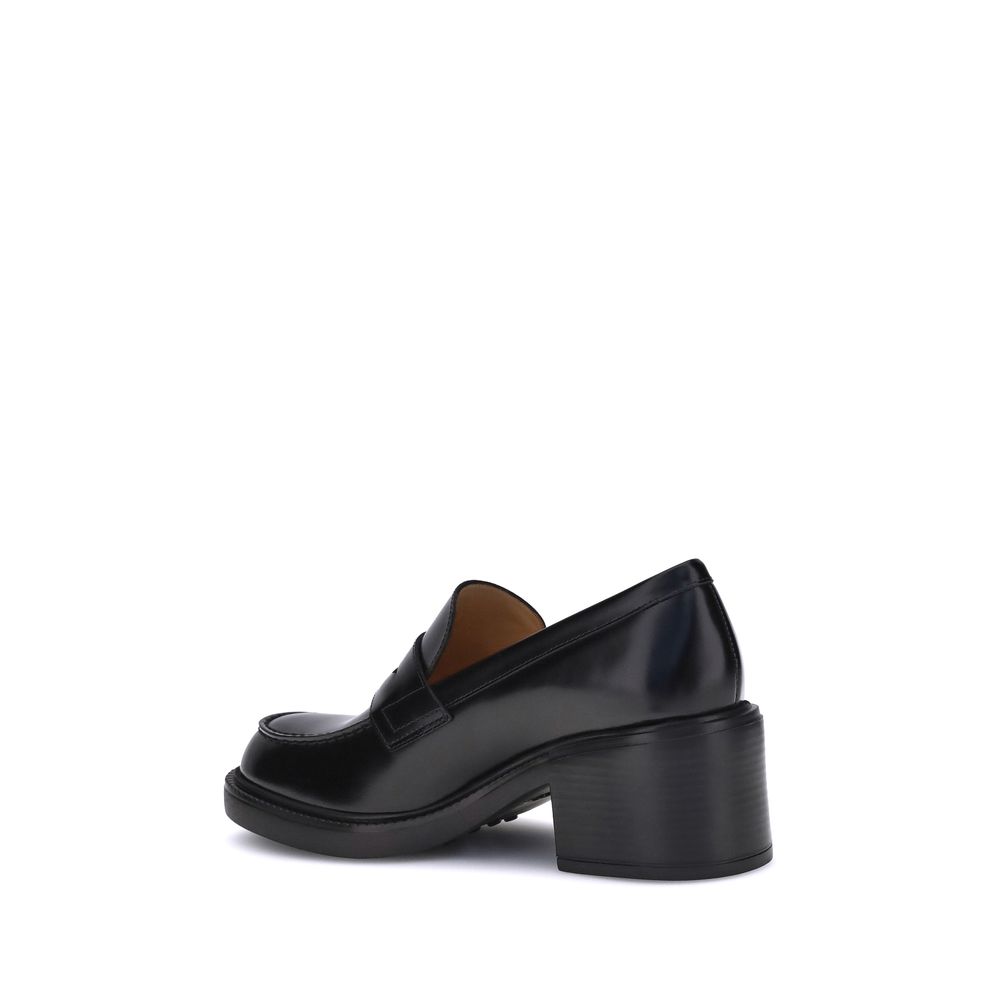 Side view of Tod's Black Calf Leather Bos Taurus Platform Loafers with chunky heel, showcasing elegant and contemporary design.