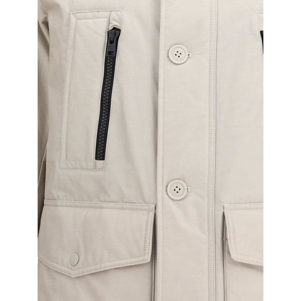 Close-up of Woolrich Beige Cotton Parka with front zipper, monogram patch, and large flap pockets, ideal for AW25 season.