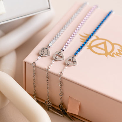 AN JEWELS JEWELRY Mod. AL.BLIYMBL. silver and blue bracelets with heart charms on a pink box