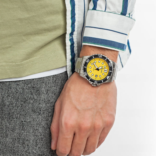 CITIZEN WATCHES Mod. NJ0170-83Z wristwatch on a man's wrist, featuring a stainless steel bracelet and yellow dial, water resistant 10 ATM.