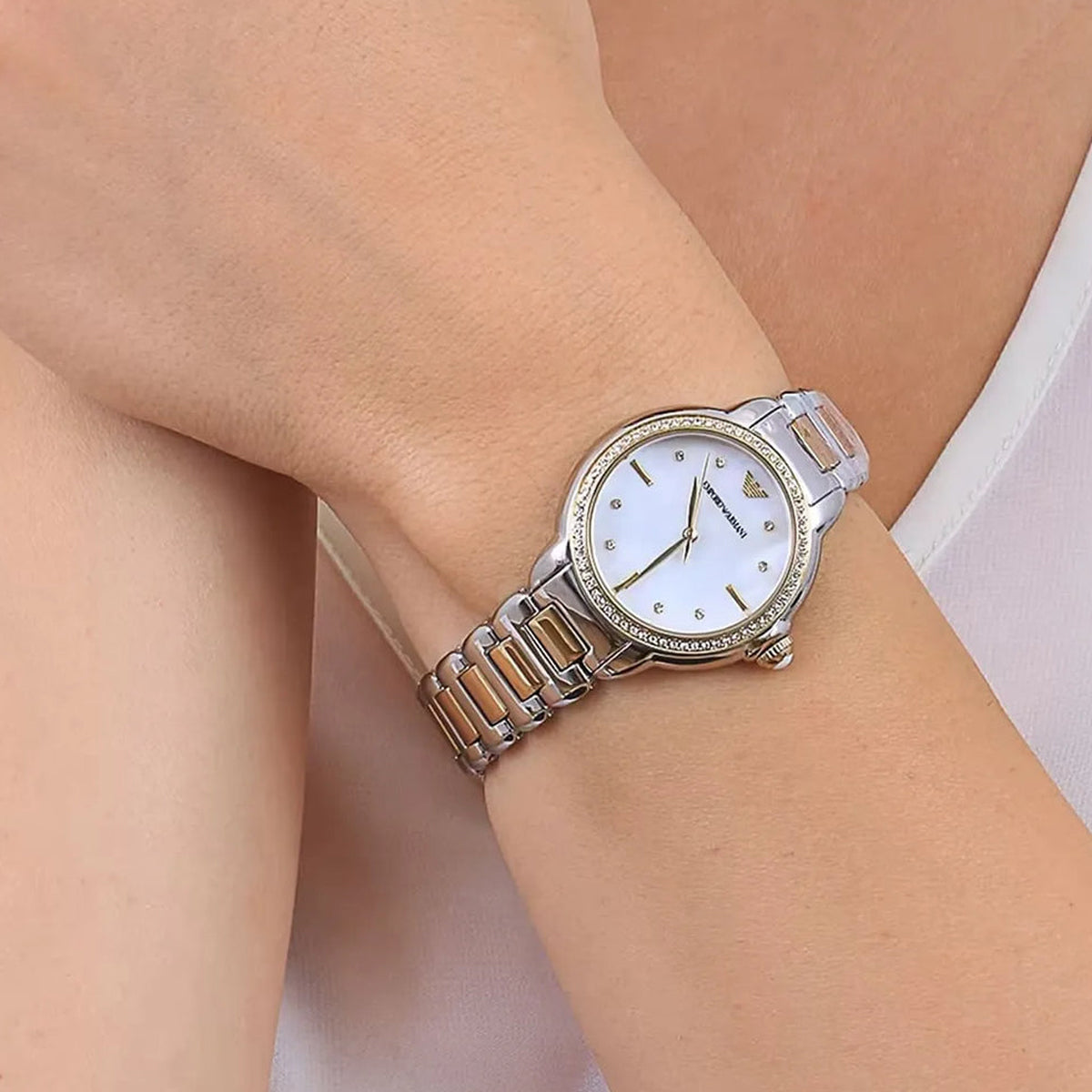 EMPORIO ARMANI Mod. MIA lady's wristwatch with stainless steel bracelet, featuring a mother of pearl dial, shown on a wrist.