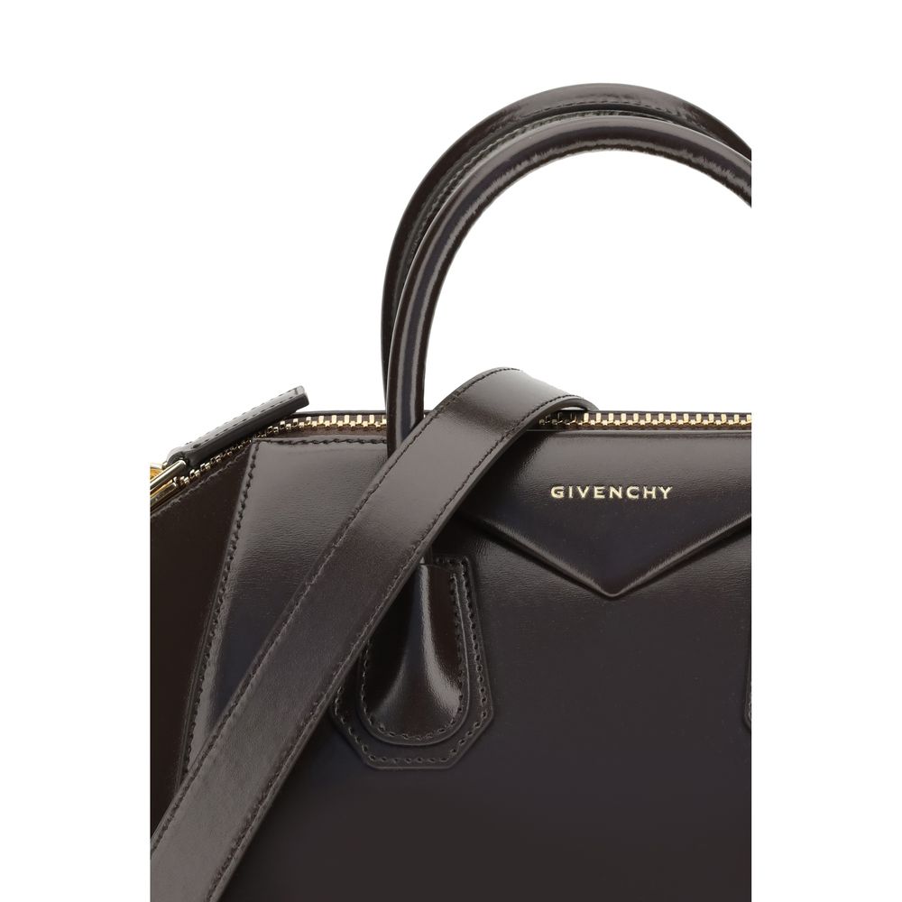 Close-up of Givenchy Brown Calf Leather Bos Taurus Handbag with logo, glossy calfskin finish, handles, and shoulder strap detail.