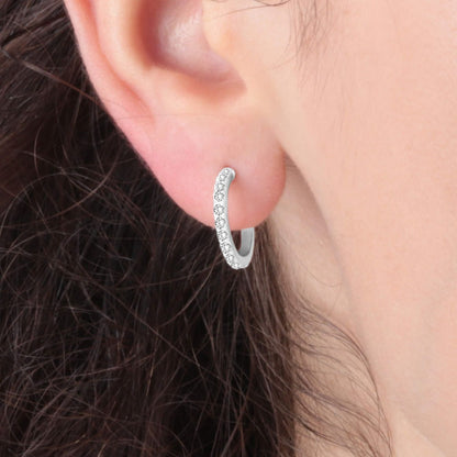 Side view of a woman wearing LA PETITE STORY JEWELRY Mod. LPS02ARQ25 silver hoop earring.