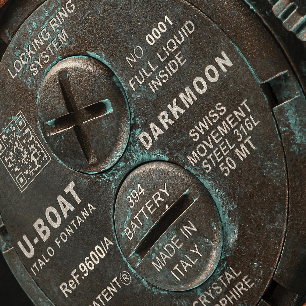 Close-up of U-BOAT WATCHES Mod. 9600/A showing the back with locking-ring system and specifications including Darkmoon and Swiss movement.