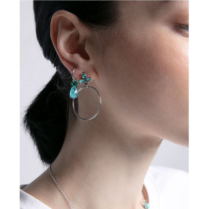 Close-up of a woman wearing VICEROY JEWELS Mod. 13196E000-93 silver 925° earrings, showcasing quartz analog design with multifunction features.