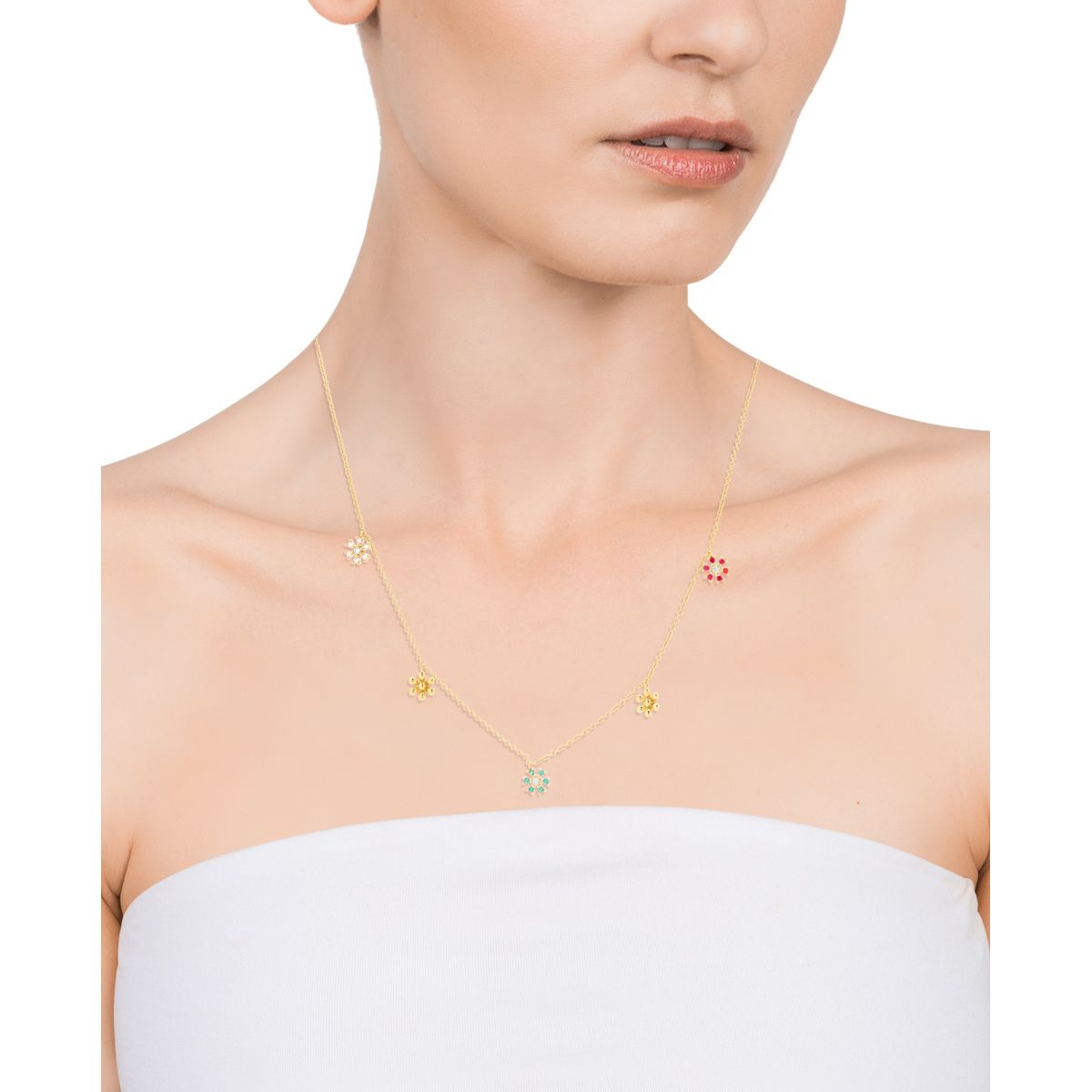 Woman wearing gold necklace with colorful flower charms on white background