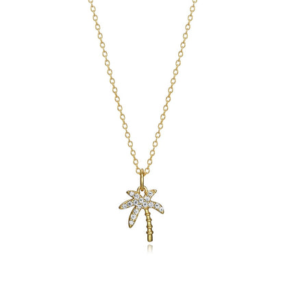 Gold necklace with a palm tree pendant adorned with crystals. Elegant and stylish jewelry piece for ladies. Perfect for chic occasions.