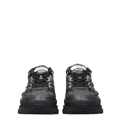 Valentino Garavani Black Fabric Athletic Sneakers with studs, front and back logos, round toe, lace-up closure, and mid heels.