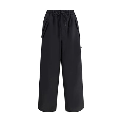 Y-3 Black Wool Casual Pants with adjustable waistband, zipper, button closure, and unique asymmetrical hem design.